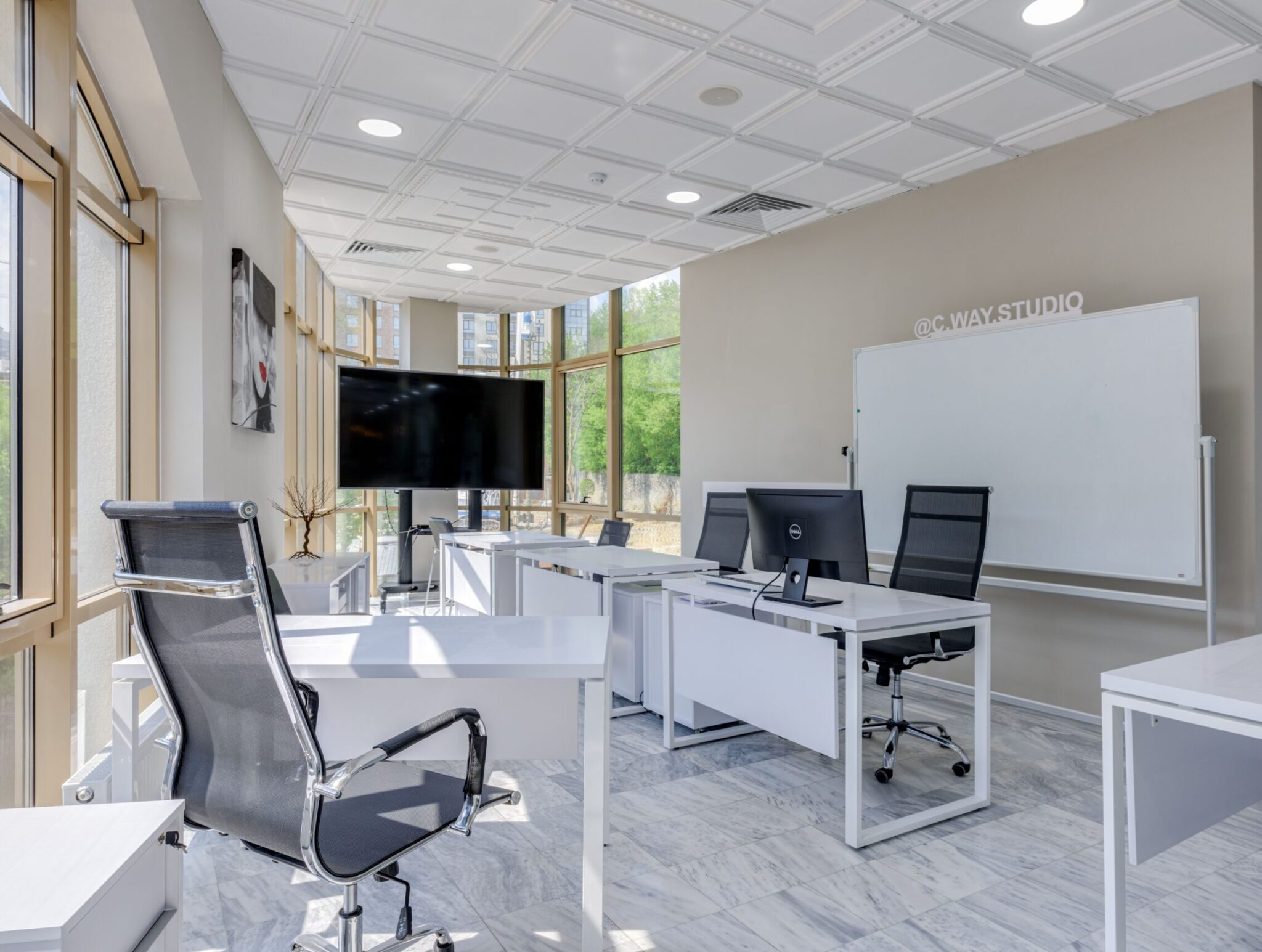 Spacious and bright modern office interior with sleek furniture, ideal for professional workspaces.